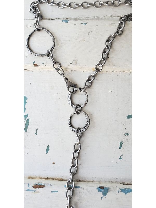 heavy silver chain necklace on white distressed wood